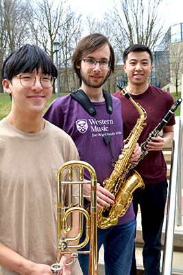 Max Zhang, Alex Rozenberg, Johnny Tan holding their instruments
